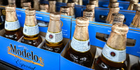 Six packs of Modelo beer on display in a store