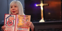 The Rev. Emma Lozano holds up a card