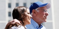 Sen. Bernie Sanders, I-Vt., and Rep. Alexandria Ocasio-Cortez, D-N.Y., look toward the crowd 