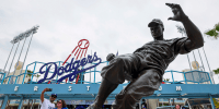 Fans take photos by Jackie Robinson statue.