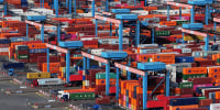  aerial view traversing cranes move shipping containers stacked 