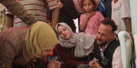 Relatives of Abir Srour, killed in an Israeli strike, mourn over her shrouded body during her funeral at the Indonesian Hospital in Beit Lahia, Gaza, on April 17, 2025. 