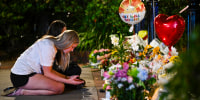 Students hold a vigil near the scene of a shooting at Florida State University