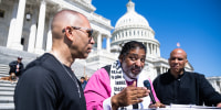 From left, Hakeem Jeffries Rev. Dr. William Barber, and Cory Booker outside of the U.S. Capitol steps