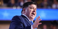JB Pritzker speaks on stage at the DNC