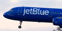 A JetBlue Airways Airbus A321 airplane approaches San Diego International Airport