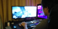A boy plays a game on a computer.
