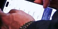 Mike Waltz checks the Signal app on his phone