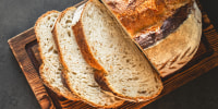 Sliced bread on dark background. Bread slices from above. Top view