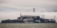 The clouds and fog shroud the Golden Gate Bridge and Alcatraz Island