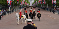 King Charles III takes the salute from the military procession for the 80th anniversary of VE Day at Buckingham Palace on Monday May 5, 2025.