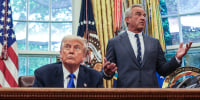 Donald Trump sits at his desk, left, in the oval office while Robert F Kennedy Jr stand behind him and speaks while gesturing