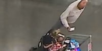 Mahendra Patel reaching toward motorized scooter occupied by Caroline Miller.