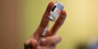 A dose of a Moderna COVID-19 vaccine is prepared in 2021.