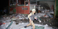 An army soldier examines a building damaged by a suspected Indian missile attack near Muzaffarabad, the capital of Pakistan controlled Kashmir