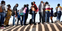 People wait in line outside