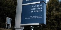 A blue National Institutes of Health sign outside