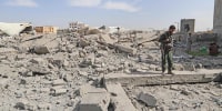 A Houthi fighter surveys the damage following overnight strikes attributed by the Yemeni media to the U.S., in Sanaa, Yemen, on April 27, 2025.