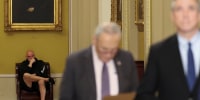 U.S. Senator Fetterman sits in the hallway behind the weekly Senate Democrat press conference at Capitol