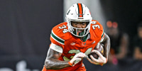 Adarius Hayes, center, runs with the football on the field