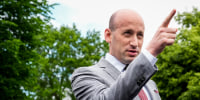 Stephen Miller points while speaking, stands outside