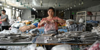 An employee packages garments at a clothing factory in Guangzhou.