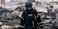 Firefighters extinguish a fire at a plastic tableware business damaged by Russian drone attack 