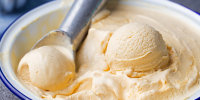 Vanilla, caramel ice cream in a bowl.