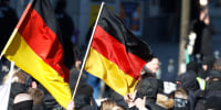 People wave German flags as they attend a march of extreme right supporters 