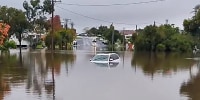 A car submerged in a flooded area