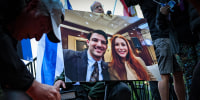 A photo of Yaron Lischinsky and Sarah Milgrim is displayed at a vigil outside the White House on May 22, 2025.
