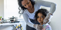 As part of her daily routine, Deysi Vargas runs a saline solution through her daughter's intravenous line before her morning shower and school. 