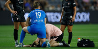 Savy King receives medical attention during the NWSL match