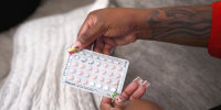 D'Asia Jackson holds her birth control pills during an interview with NBC News sickle cell disease