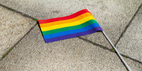 A pride flag on the ground