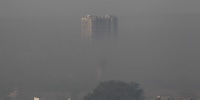 A residential building engulfed in smog in the morning in Faridabad district of India's Haryana state, on April 26, 2025. 