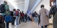 Travelers wait to go through security at San Francisco International Airport on May 23, 2025.