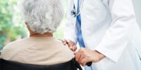 Doctor help Asian elderly woman disability patient in nursing hospital, medical concept.