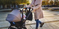 woman pushing baby stroller