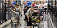 Shoppers browse the frozen food cases