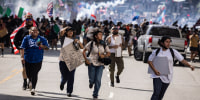 Protesters flee clashes with police.