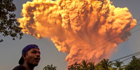 A villager watches the eruption of Mount Lewotobi Laki-Laki 
