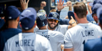 Tampa Bay Rays shortstop Jose Caballero (77) hugs designated hitter Brandon Lowe (8) after he scored on his sacrifice.