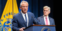 Image: Medicare and Medicaid Administrator Mehmet Oz, right, listens to Secretary of Health and Human Services Robert F. Kennedy Jr. speak