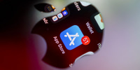 The App Store application is displayed through reflection of the Apple logo