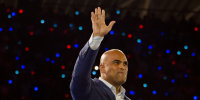 Colin Allred waves during a campaign rally for Kamala Harris in 2024.