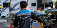 An Amazon worker delivers a package
