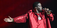 Sean "Diddy" Combs performs on stage, wearing all red