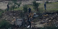 Men survey damage left by a raging Guadalupe River