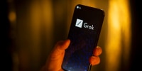 The Grok AI logo on a phone screen.